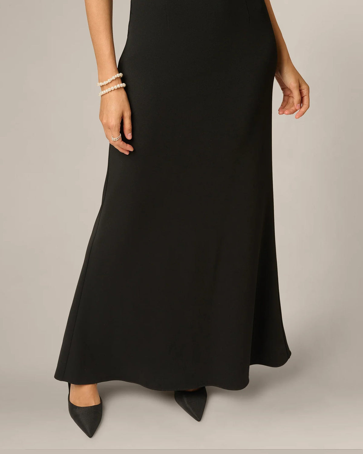 Black A-line maxi dress with long skirt hem and side seams