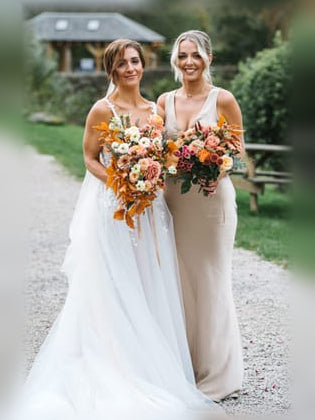 White satin V-neck sheath maxi dress, sleeveless, open back with draped knot.