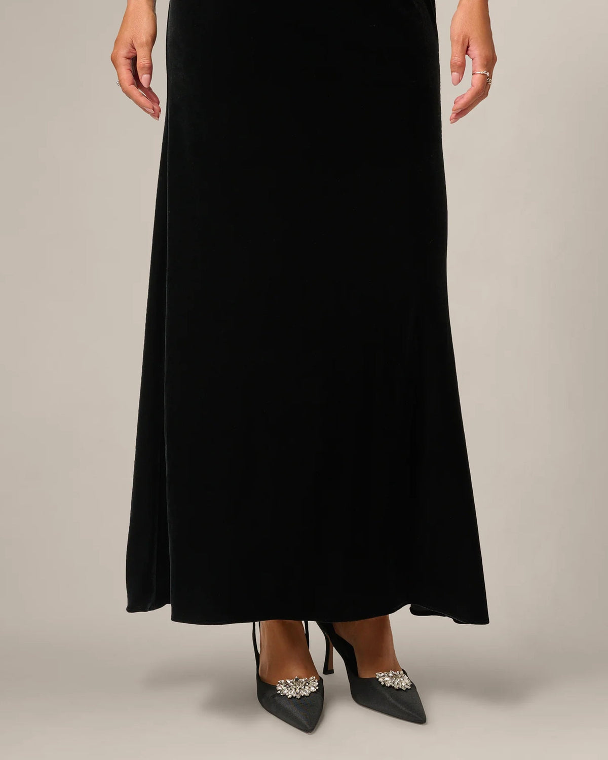 Black A-line maxi dress hem with split detail and jeweled shoe accent