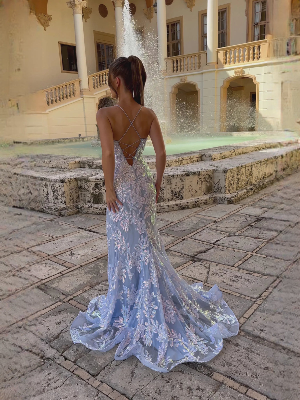 Light blue floral print spaghetti strap dress with open back, front slit, ruffled train