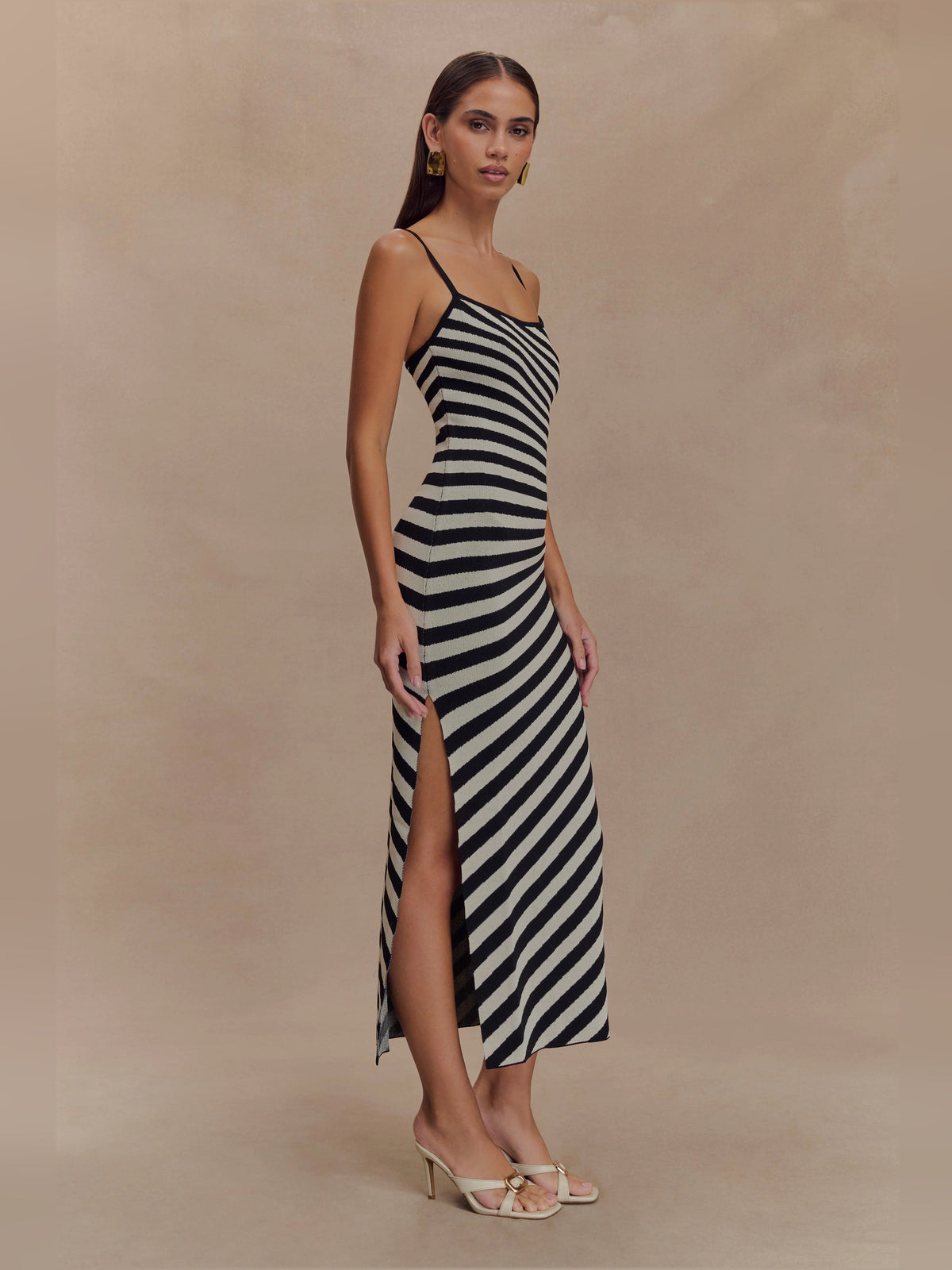 Black-and-white striped knit midi dress with spaghetti straps and front slit hem