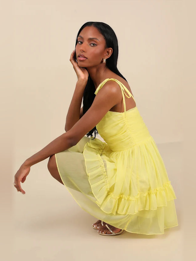 Yellow chiffon mini dress with tiered ruffles and tied shoulder straps