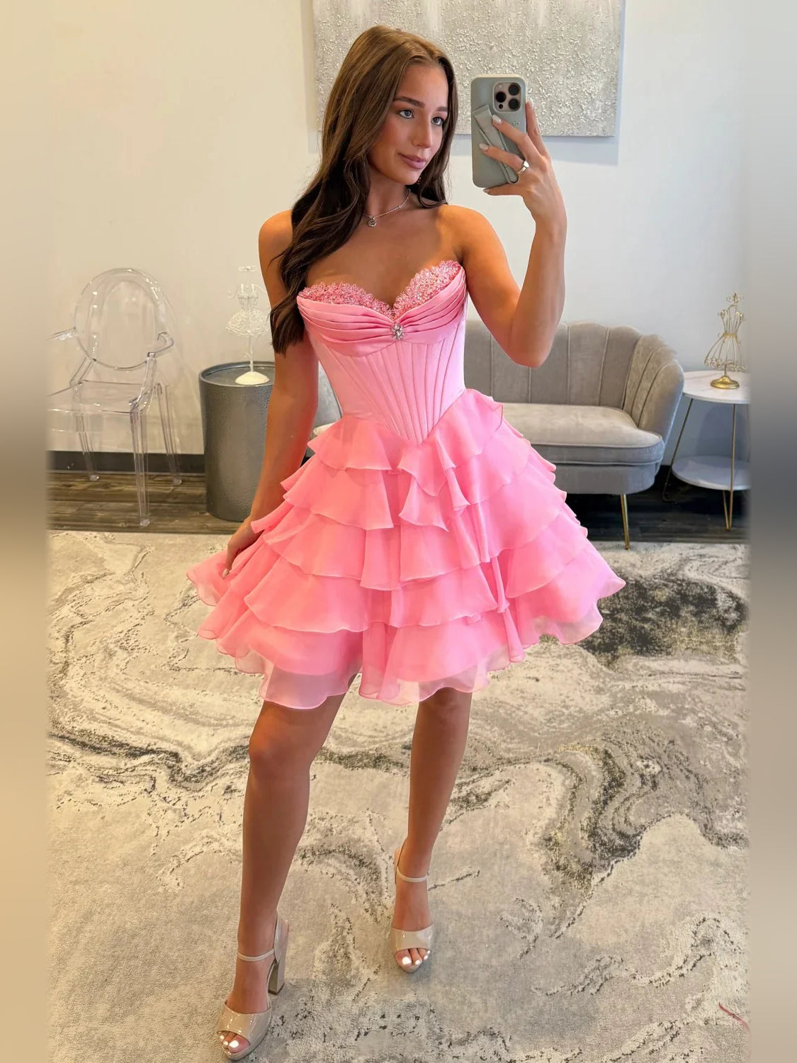 Pink satin corset dress with sweetheart neckline and tiered ruffle skirt