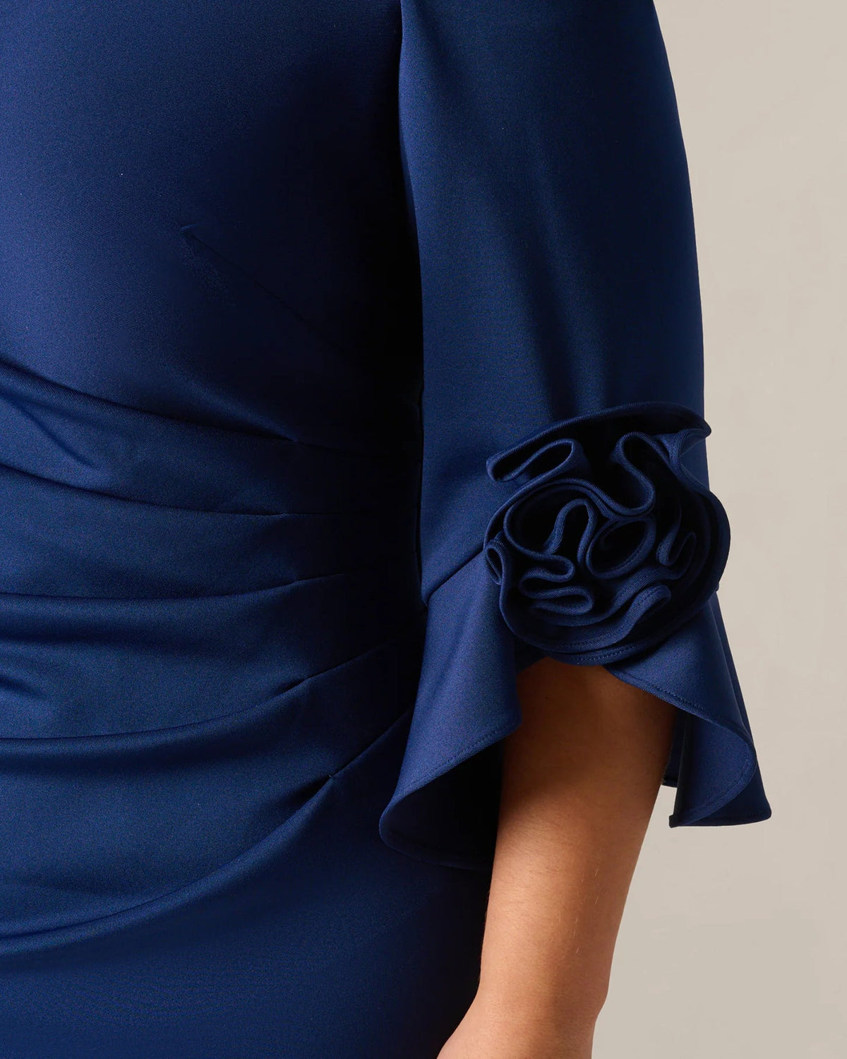 Navy maxi dress sleeve, layered rosette and flowing flounce cuff detail