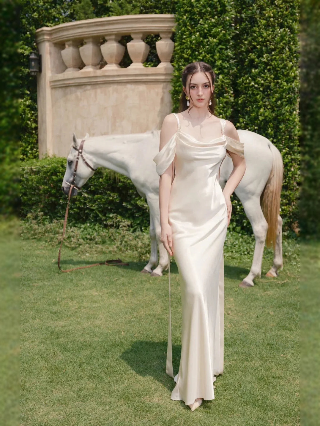 Ivory satin sheath wedding dress with draped cowl neck, fitted skirt, and side slit