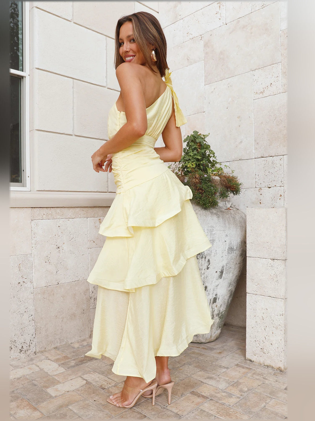 Yellow one-shoulder tiered midi formal dress, side view with layered skirt tiers