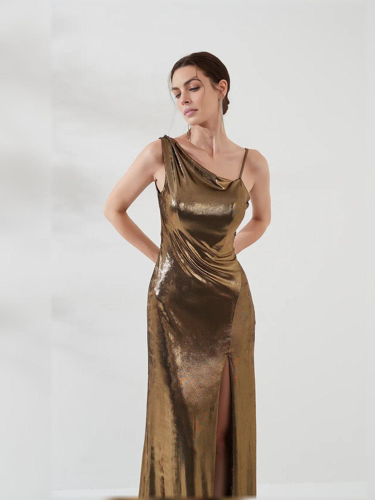Gold one-shoulder satin mermaid gown close-up with draped bodice and side slit
