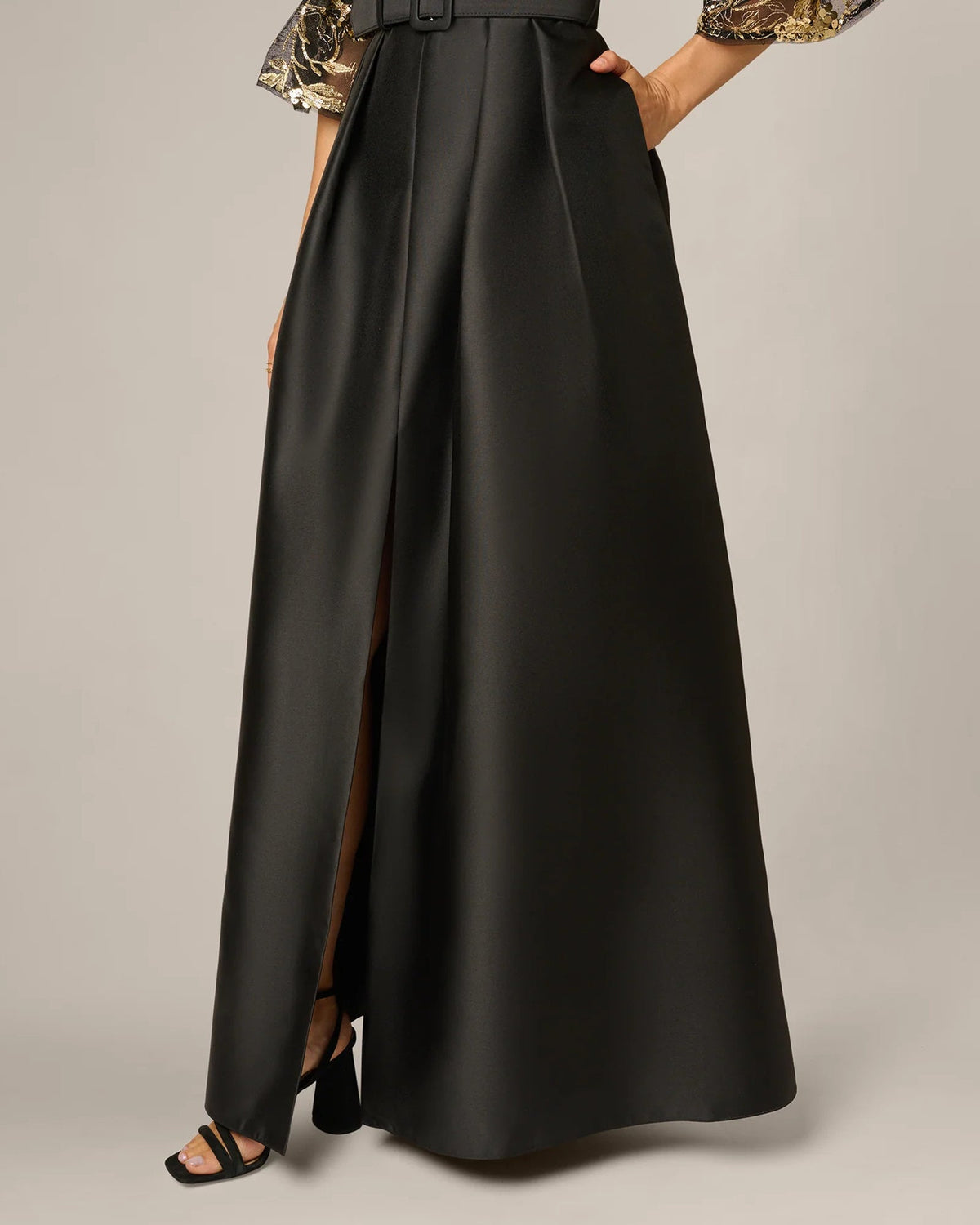 Black satin A-line maxi skirt with front slit and wide waist belt
