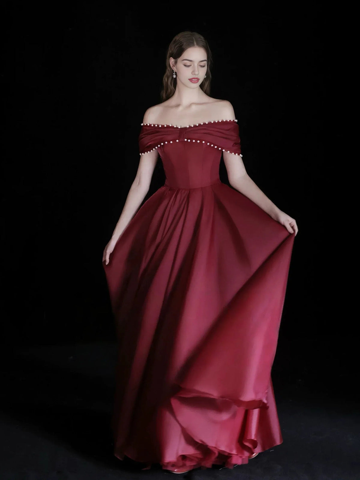 Burgundy off-shoulder corset formal dress with beaded neckline and flowing layered skirt