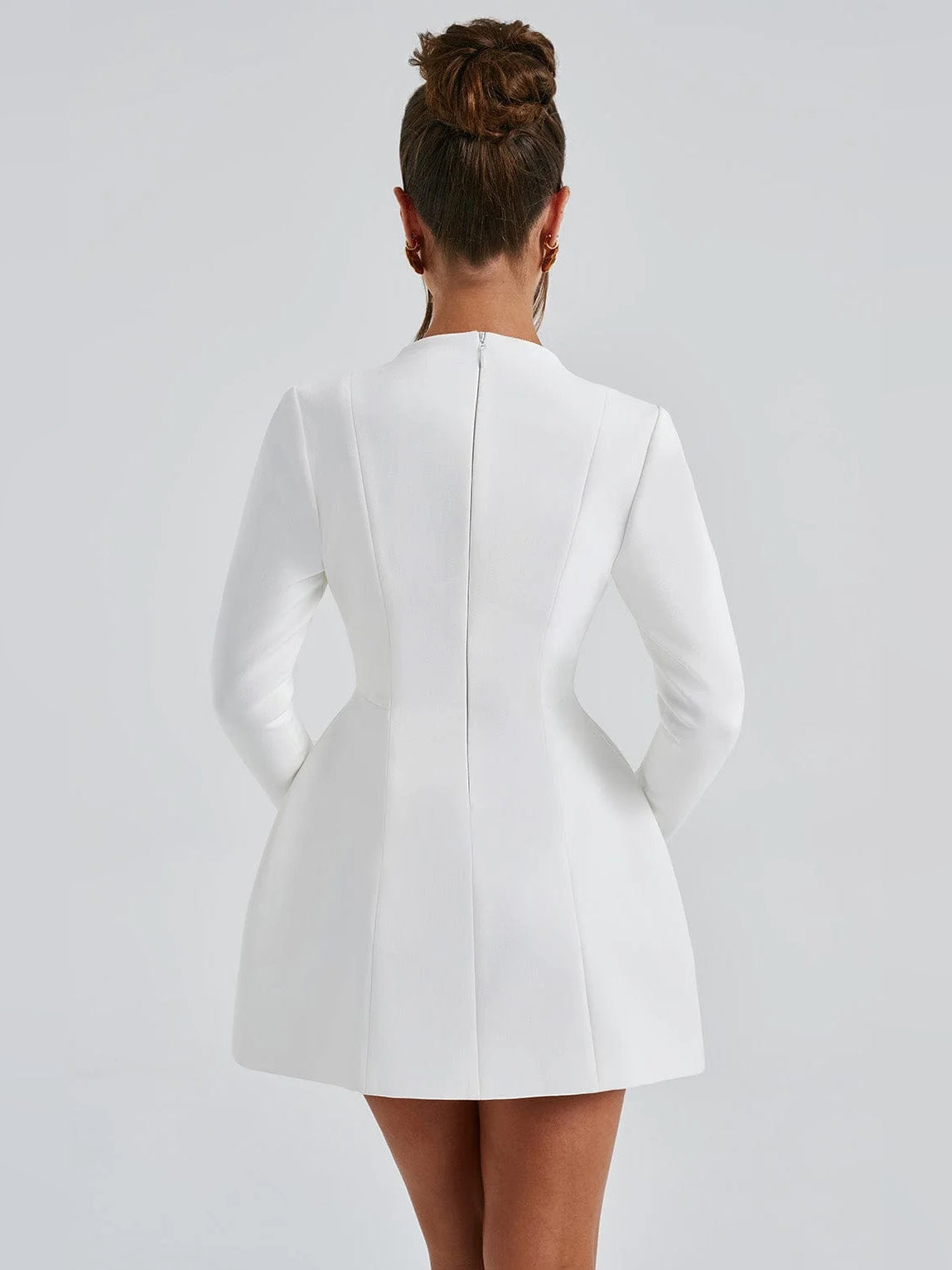 Ivory mini dress back view with long sleeves and center seam; flared skirt