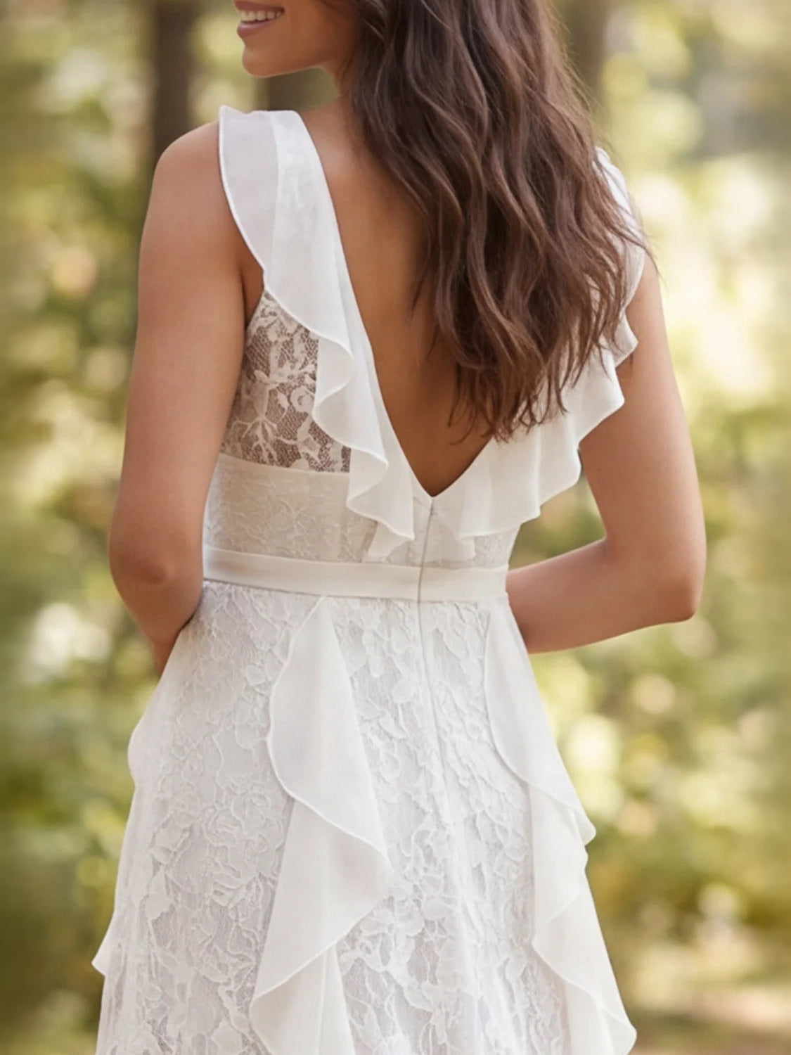Ivory sleeveless V-neck wedding dress with open back and layered ruffle trim