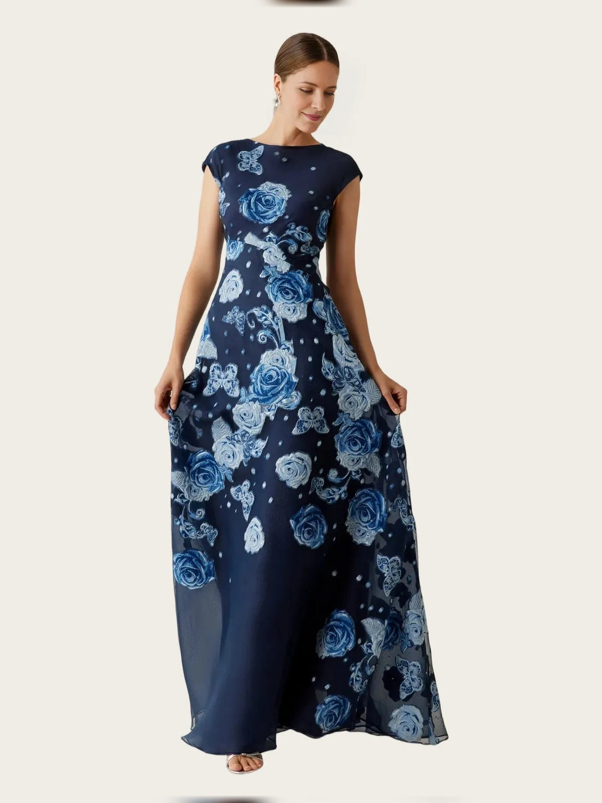 Navy A-line maxi dress with round neck and cap sleeves, blue rose floral print and sheer overlay