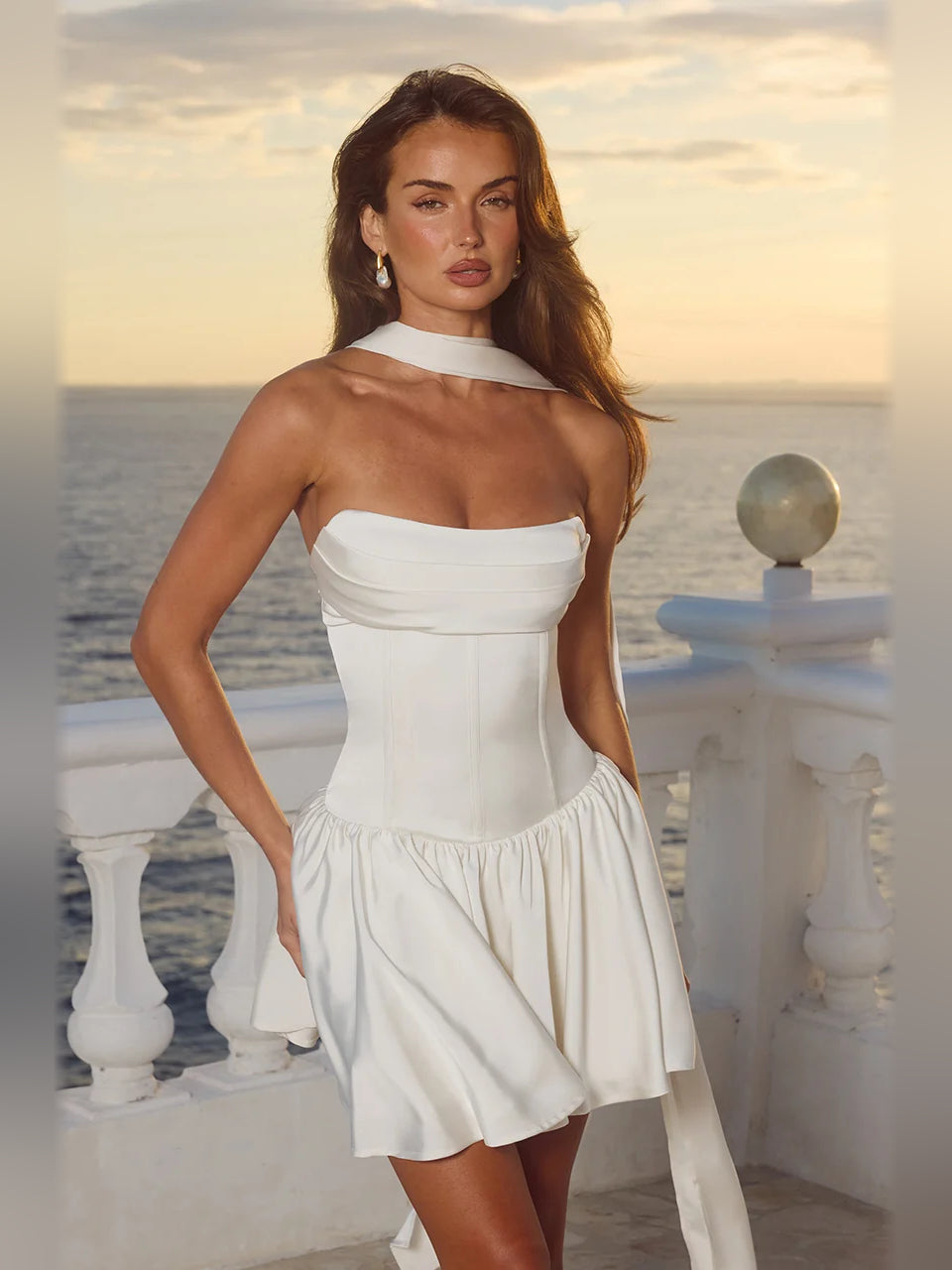 Ivory strapless mini dress with high halter neckline, fitted bodice, and flared hem