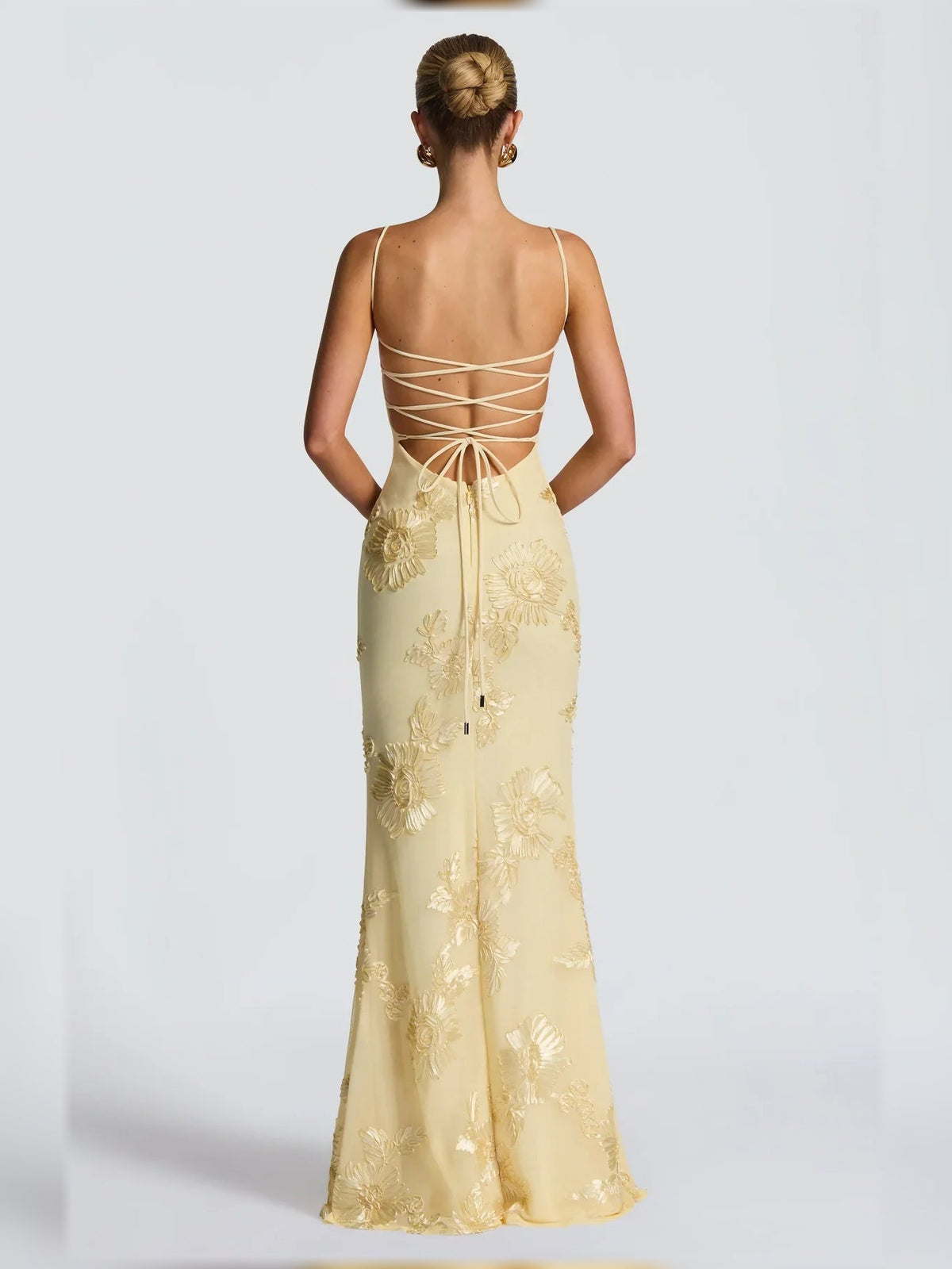 Back view of pale lemon corset formal dress with crisscross lace-up straps
