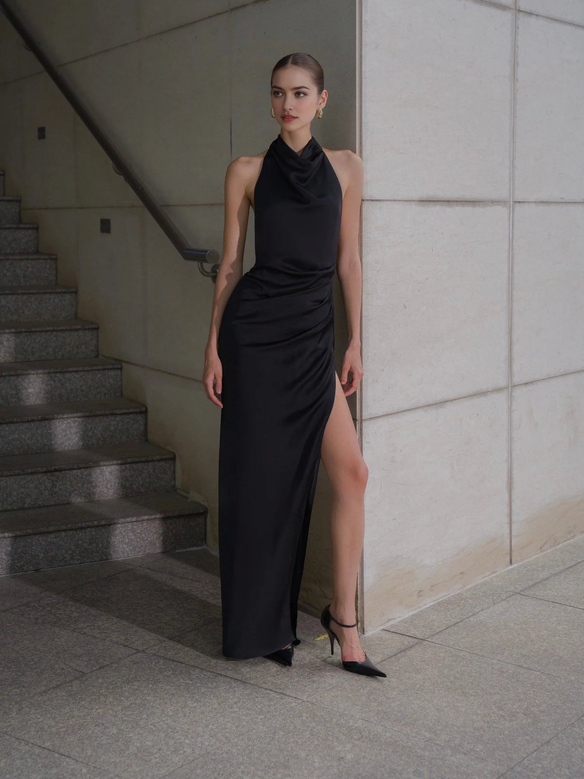 Black satin halter sheath gown with ruched neckline and thigh-high slit