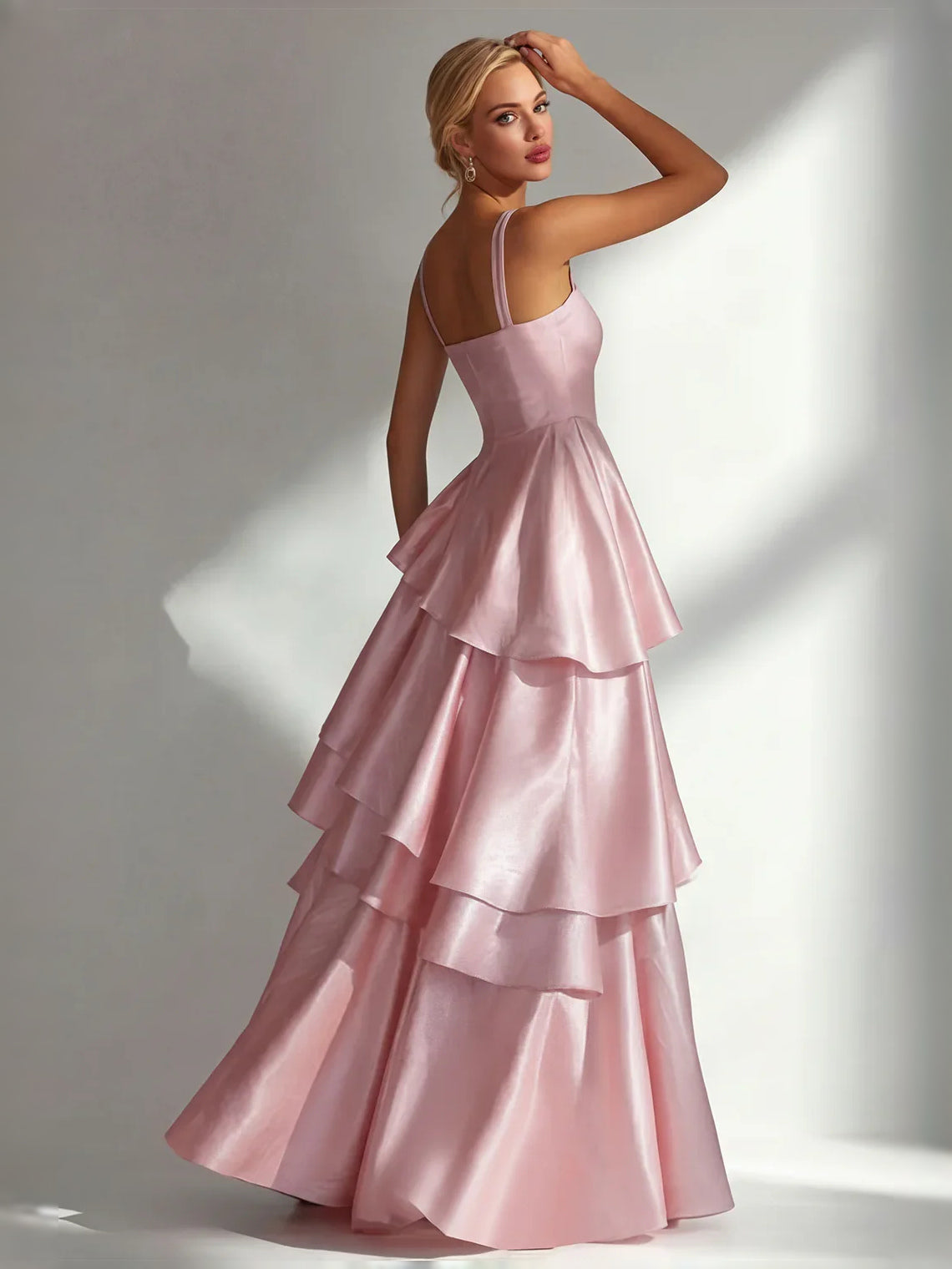 Light pink satin prom dress with square neckline, thin straps, and tiered ruffle A-line skirt.