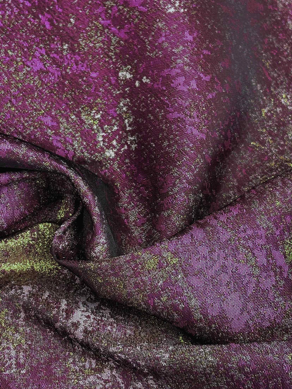 Close-up of plum purple metallic floral fabric with gathered drape folds