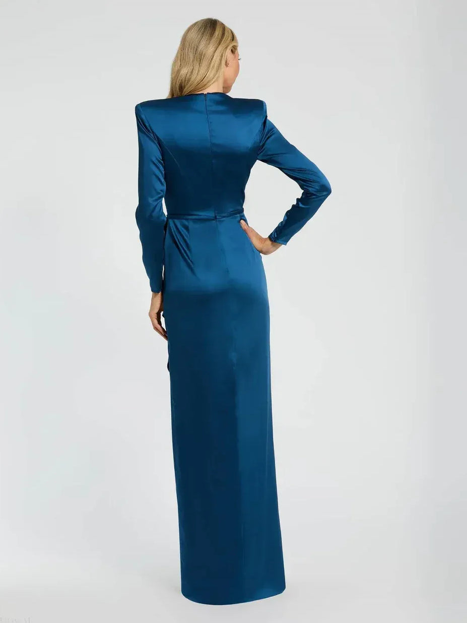 Floor-length formal dress in lapis blue, back view, long sleeves, waist ruffle bow