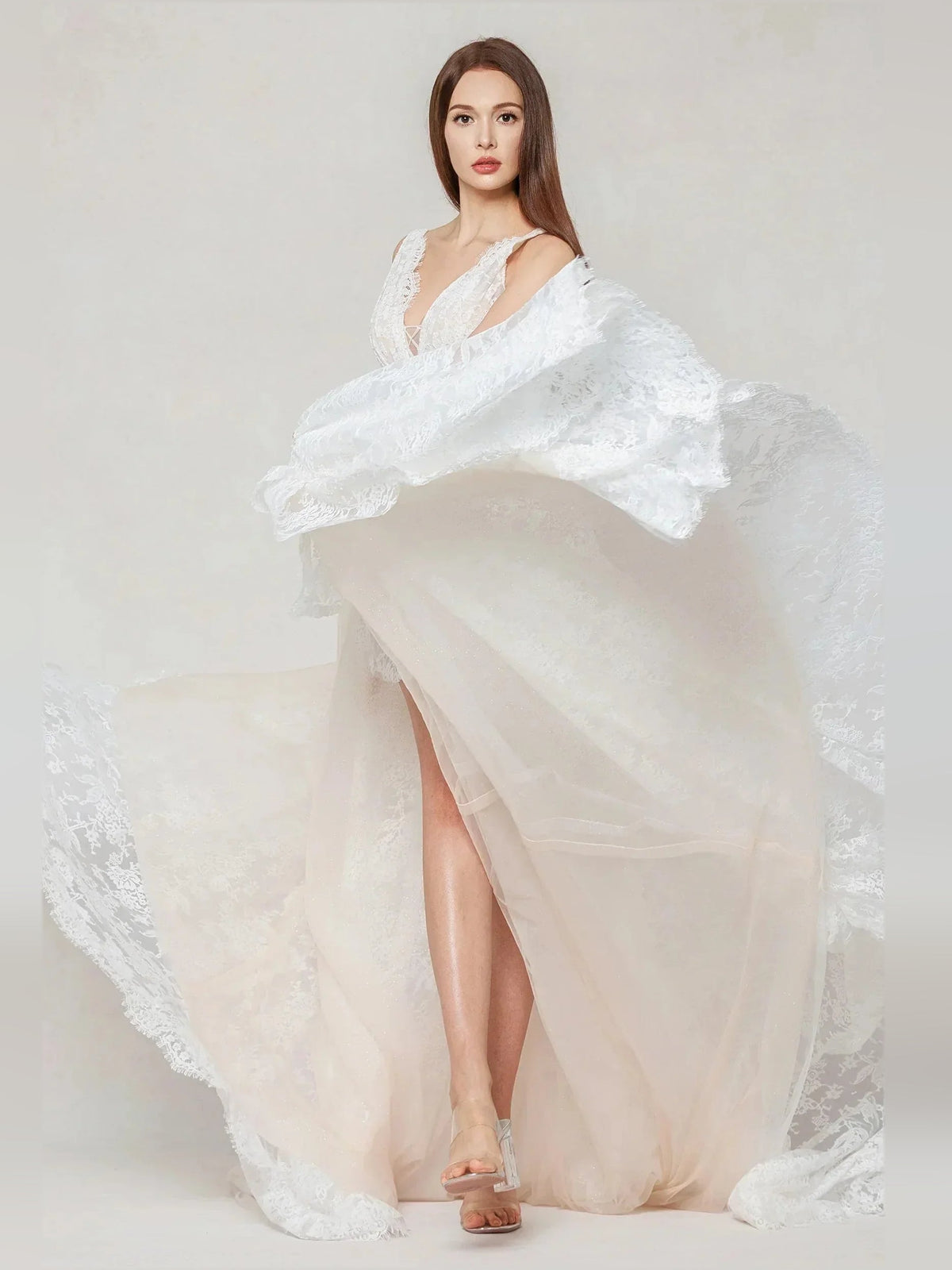 Ivory sleeveless lace wedding dress with V-neck, thigh-high slit, flowing train