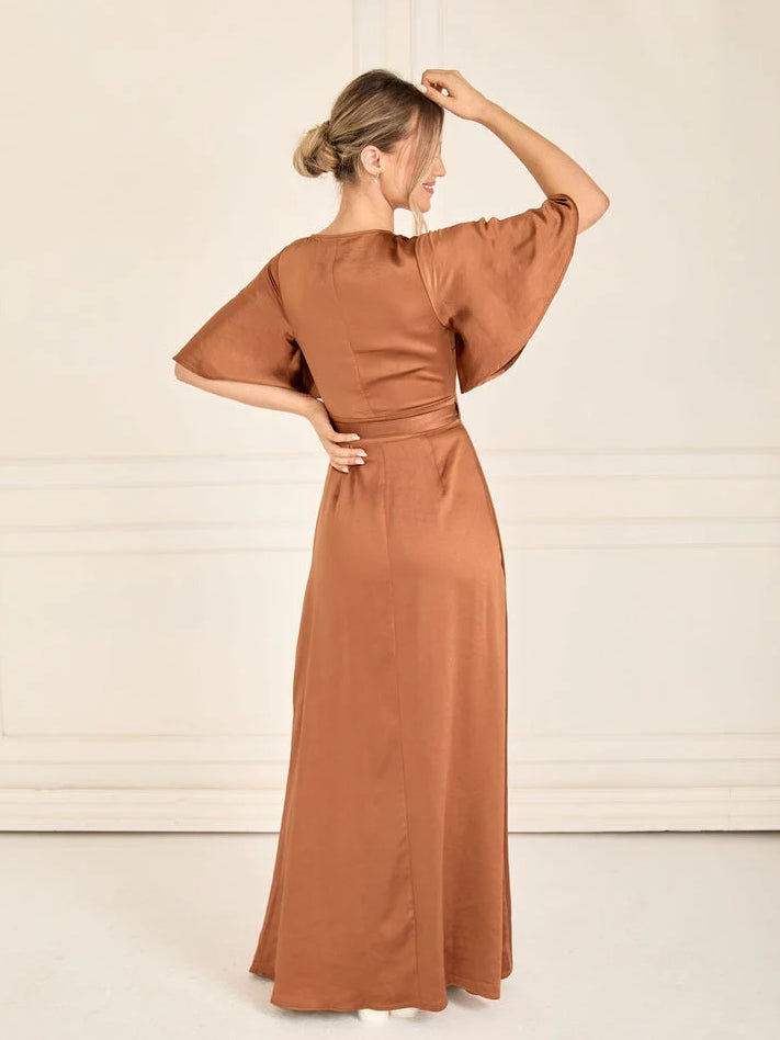 Rust satin wrap bridesmaid dress with V-neck, tie waist, and side slit