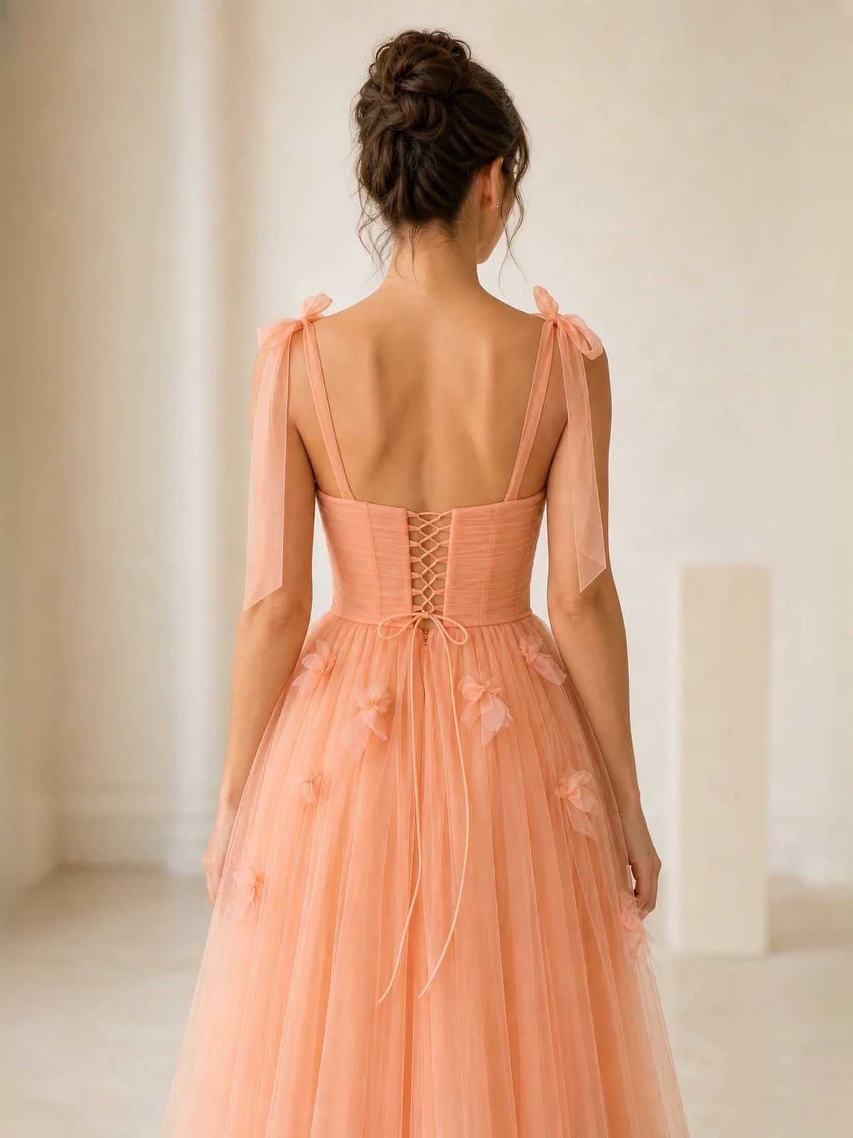Orange back view corset tulle prom dress with lace-up detailing and bow straps