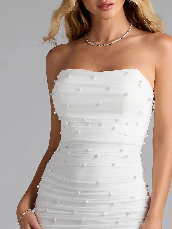 Close-up: White strapless mini dress bodice with pearl-like beaded embellishments