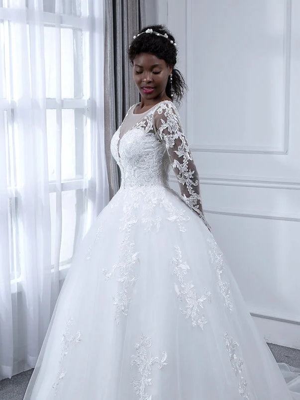 Ivory A-line tulle wedding dress with floral lace detailing, round neck, long sleeves, front view