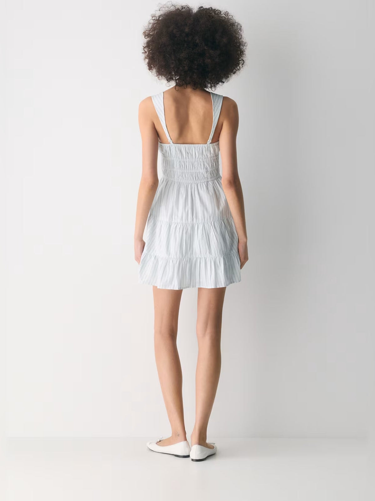 Light blue tiered mini dress with thin straps and open back