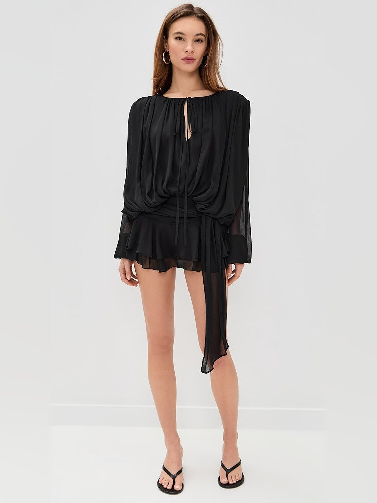 Black mini dress with keyhole neckline, long sleeves, and layered ruffle hem