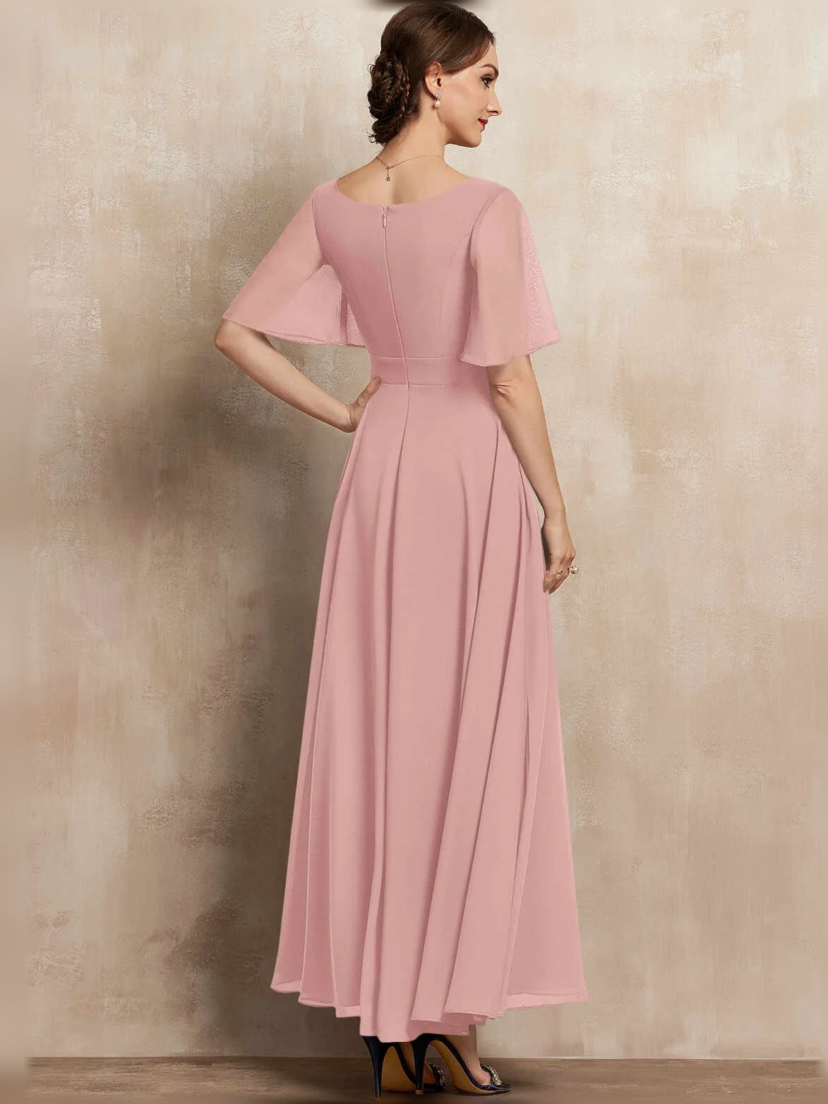 Blush pink chiffon maxi dress with V-neck, pleated A-line skirt, flutter sleeves, and beaded waist