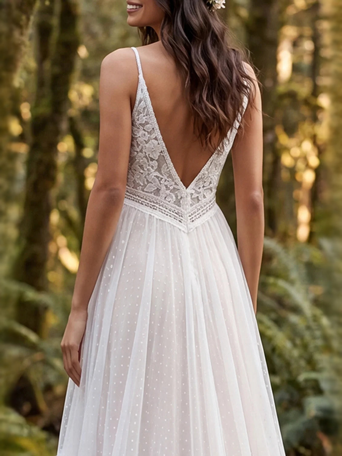 Ivory tulle wedding dress with lace V-back bodice and tiered ruffled skirt