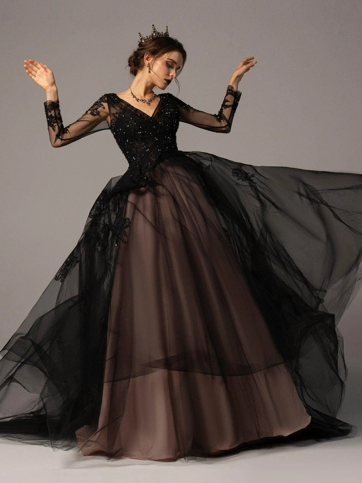 Black V-neck A-line wedding dress with corset bodice, sheer floral sleeves, and billowing tulle