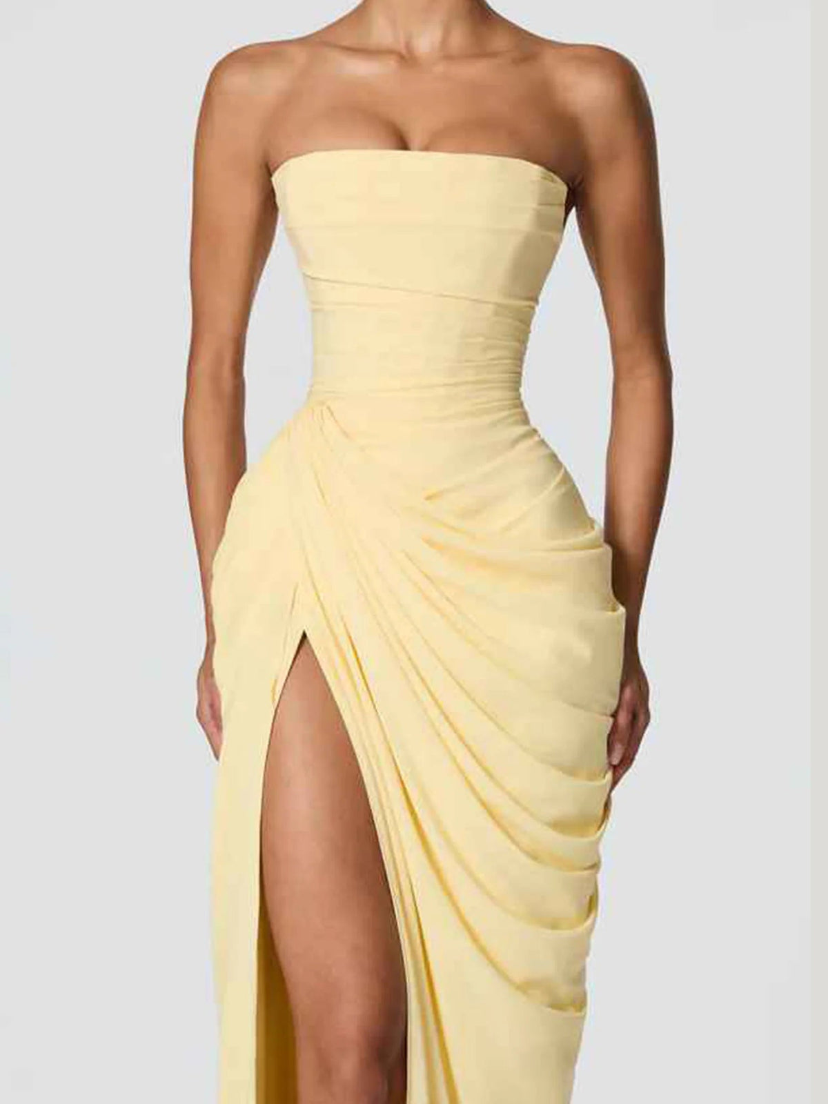 Yellow strapless ruched draped bodice with layered fabric and thigh-high slit