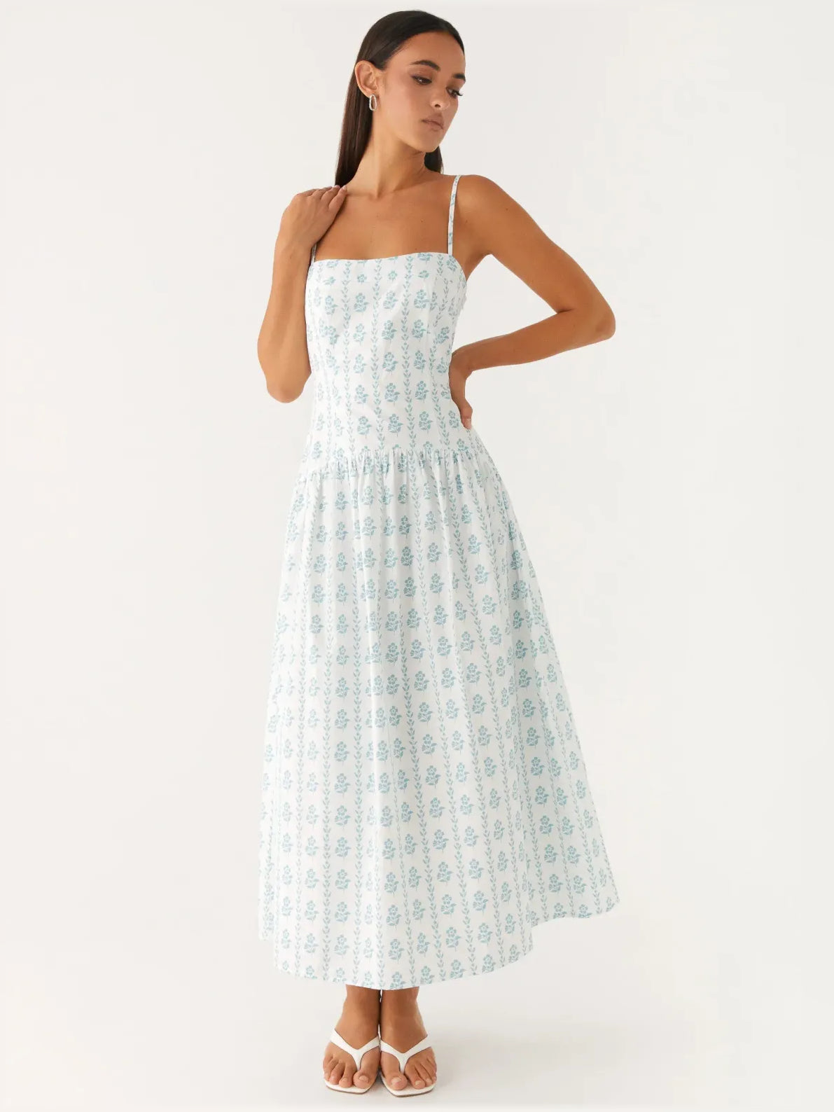 Light blue printed midi dress with square neckline, thin straps, and tiered skirt