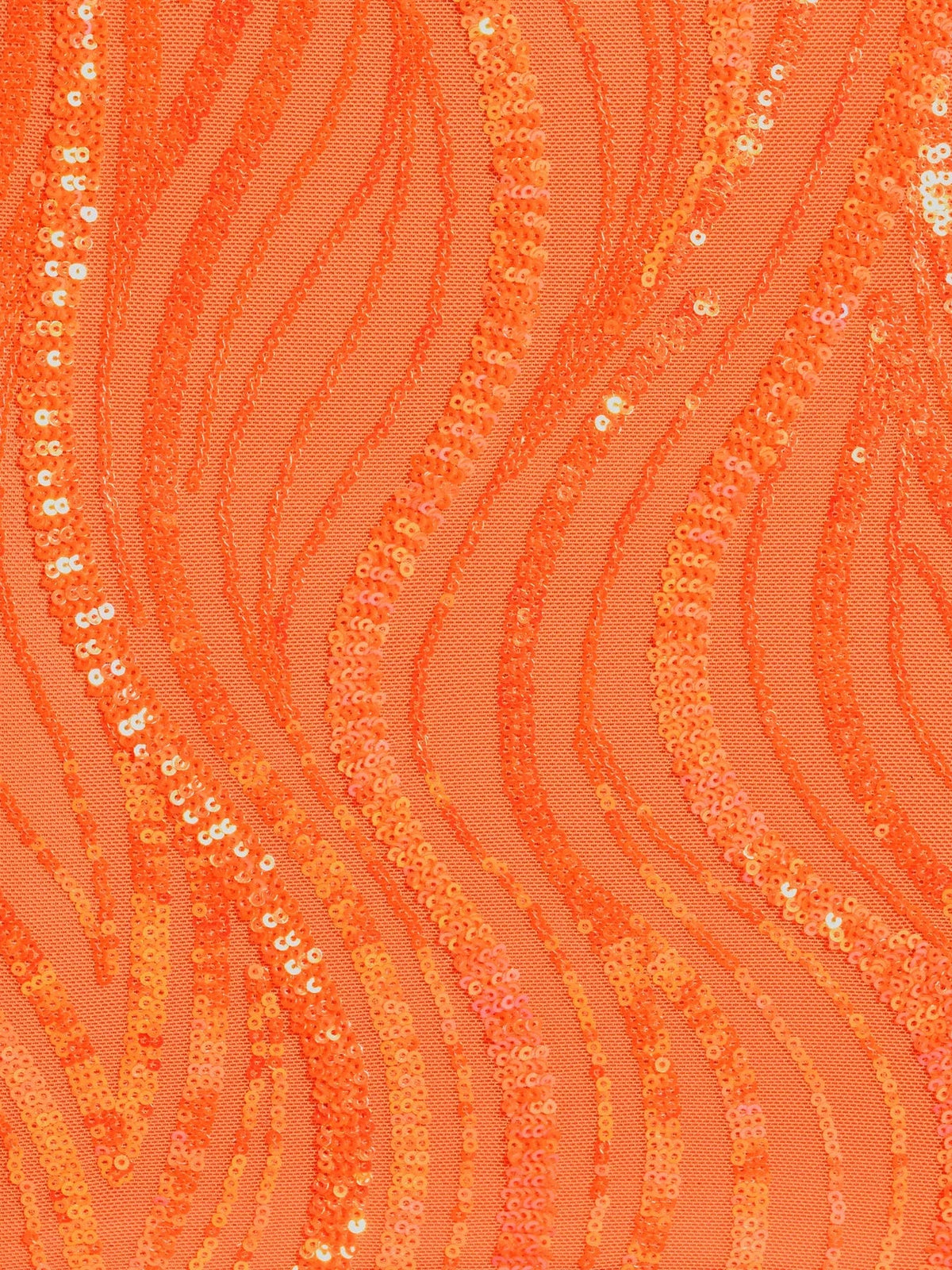 Close-up of orange sequin fabric with shimmering wave pattern