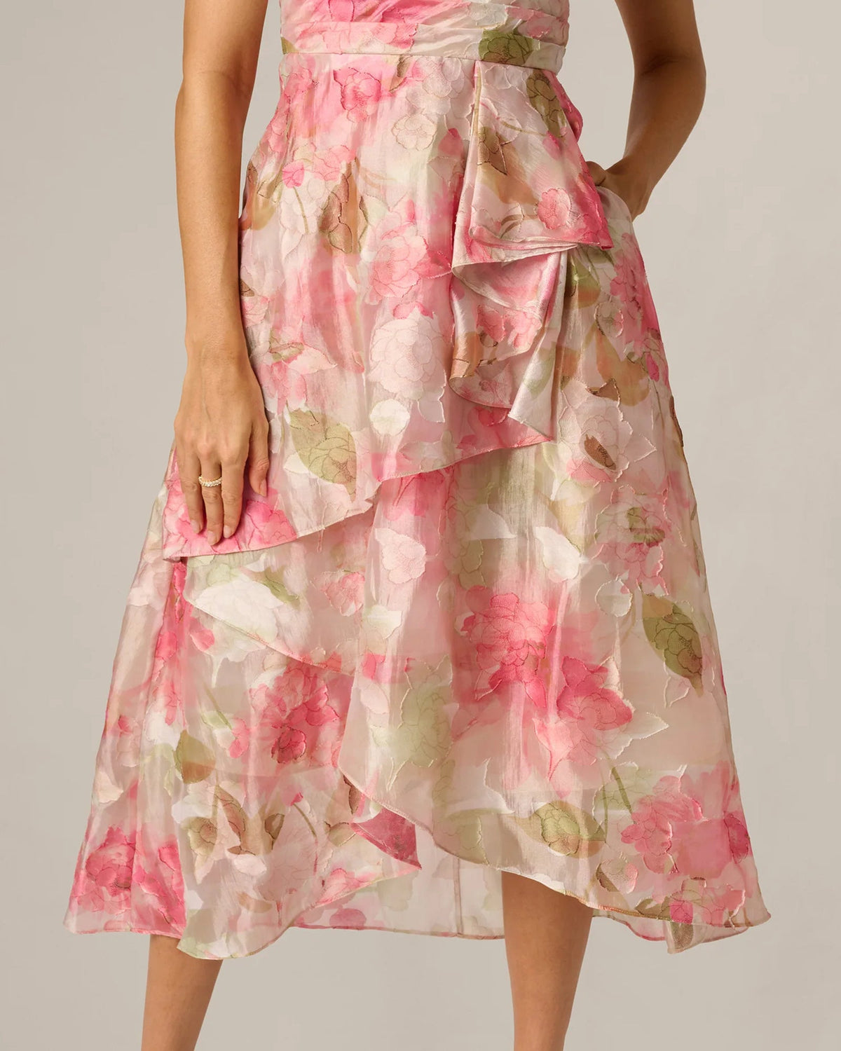Floral A-line midi dress with layered chiffon tiers and bow accent at waist, pink print