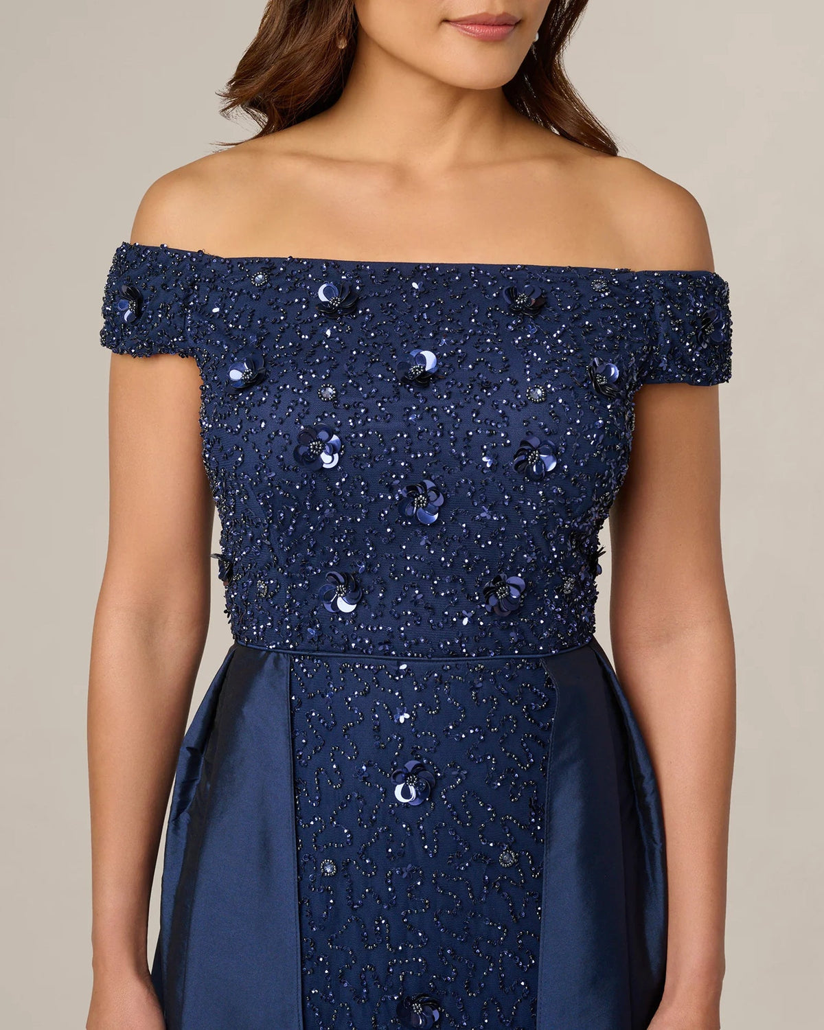 Off-shoulder light navy sequin dress with sparkling embellishment across the bodice