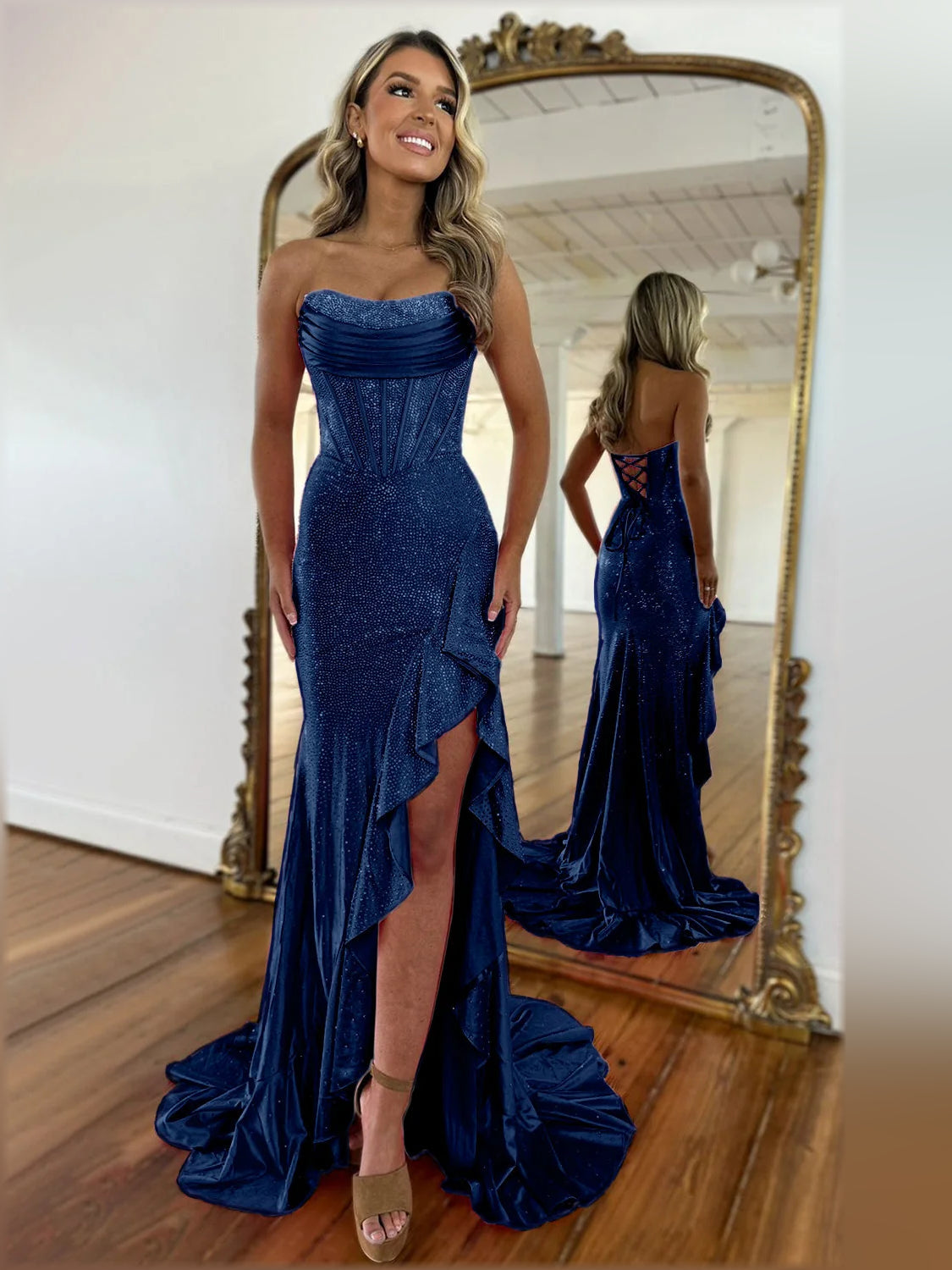 Dark navy strapless mermaid formal dress with sparkling fabric and front leg slit.