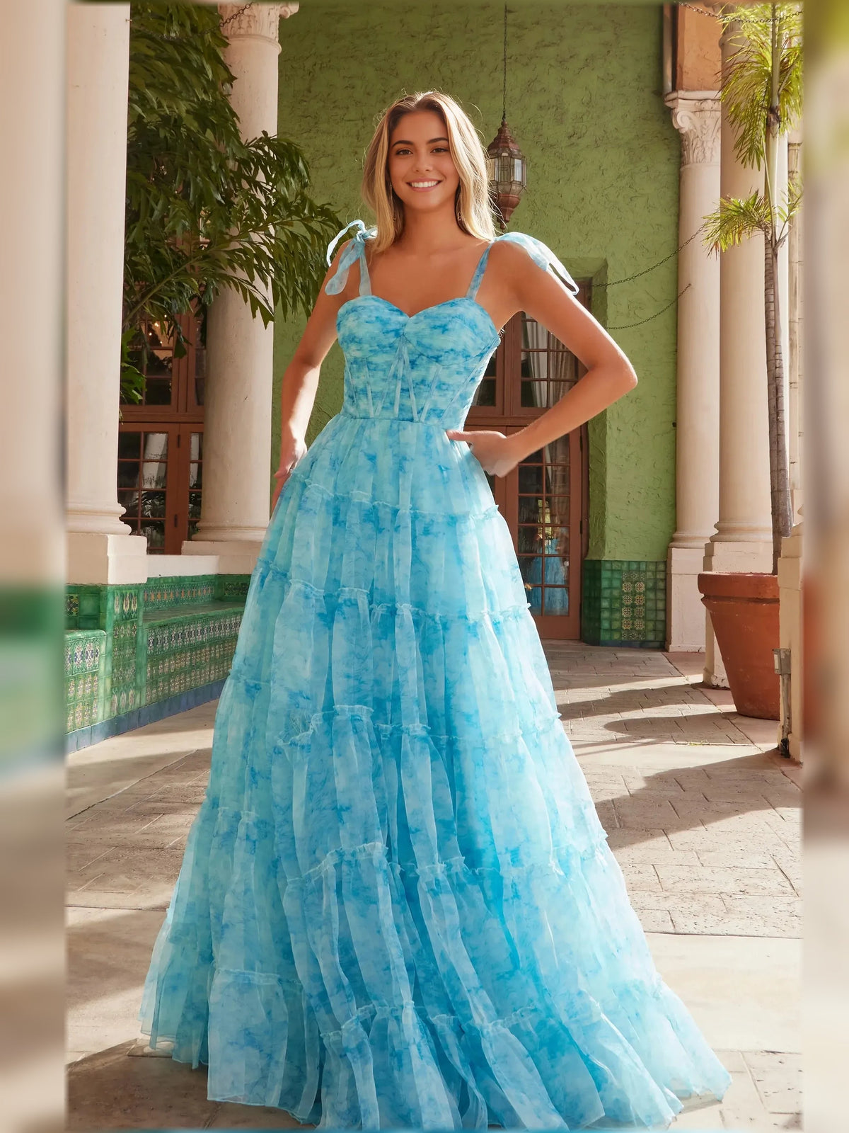Blue sweetheart corset formal dress with tiered skirt and bow shoulder ties