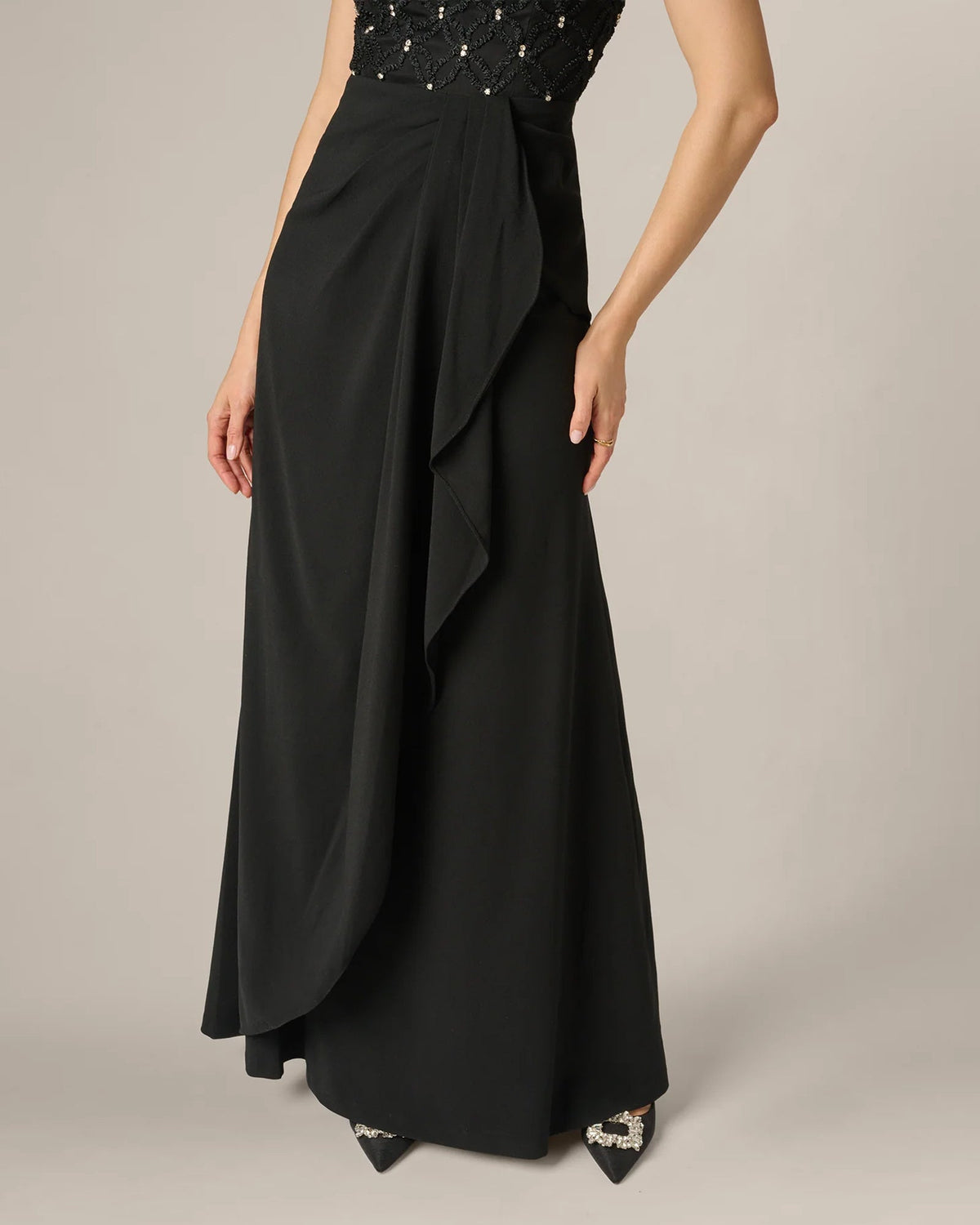 Black draped A-line maxi skirt with asymmetrical overlay and sleeveless bodice