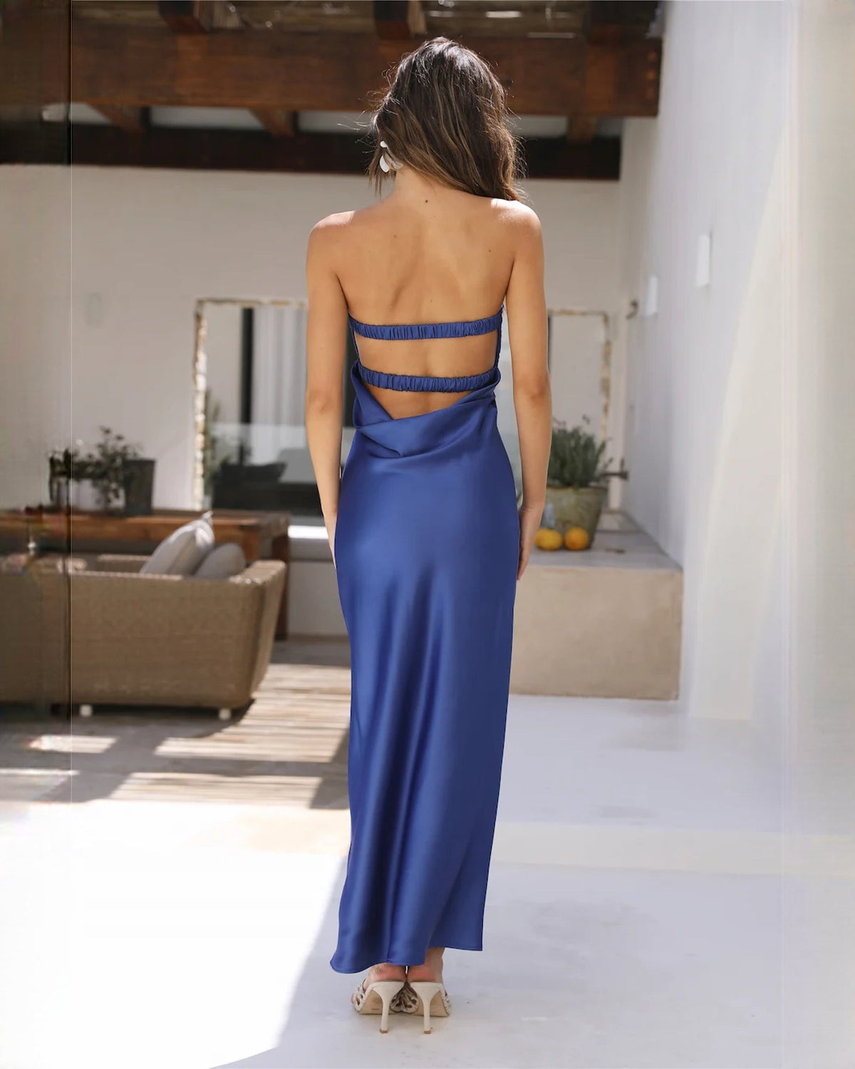 Blue satin sleeveless maxi dress with crisscross open back and low scoop neckline