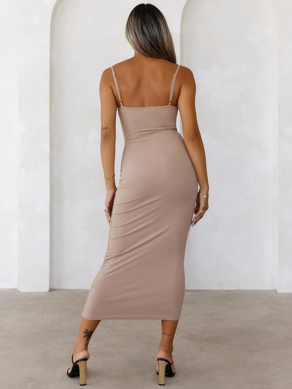 Back view: taupe ribbed midi dress with thin straps and tapered waist