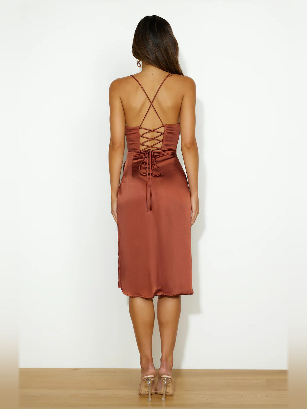 Back view: Brown satin midi dress with crisscross straps and tie detail