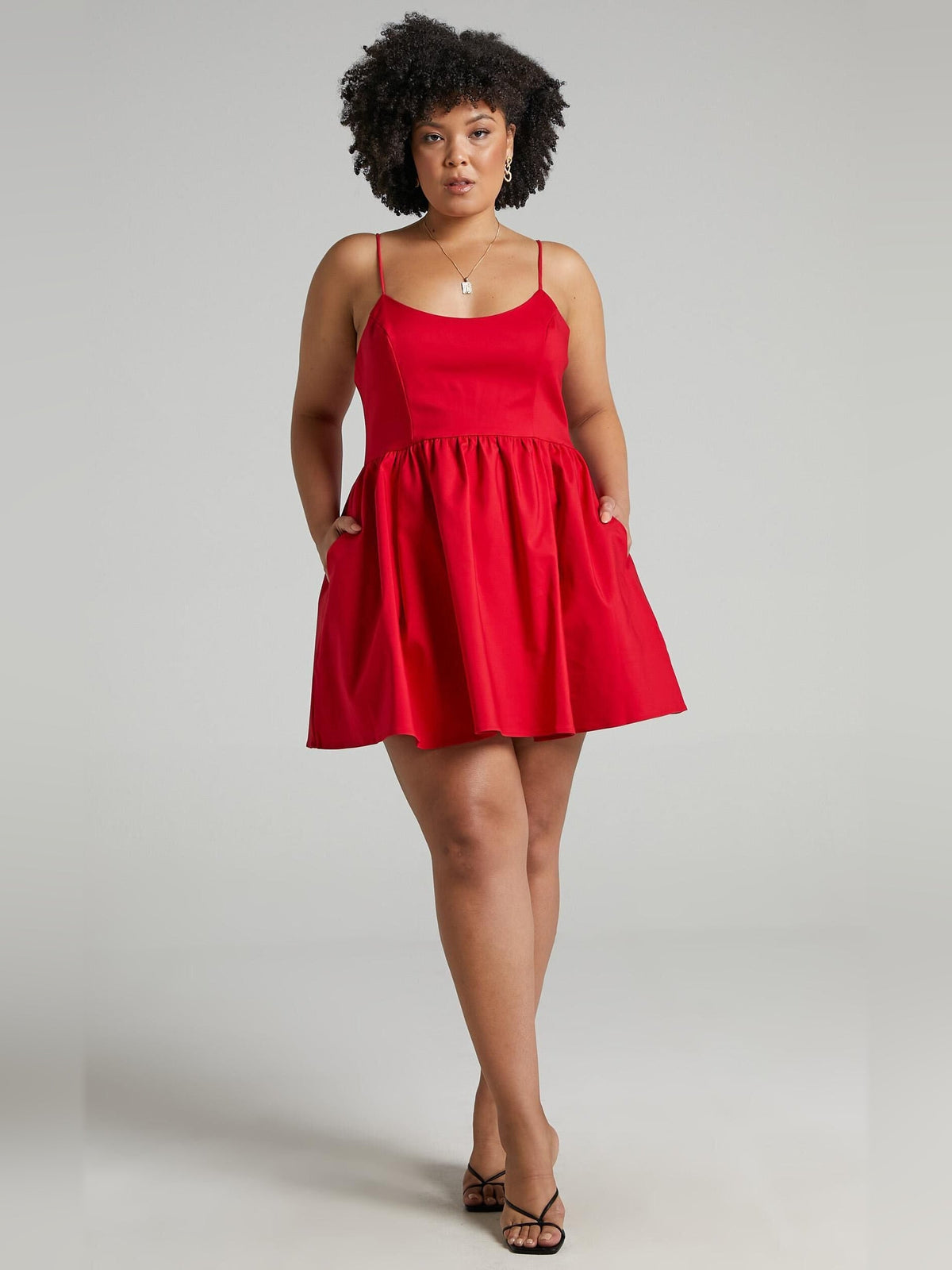 Red A-line mini dress with spaghetti straps and gathered waist, flared swing hem