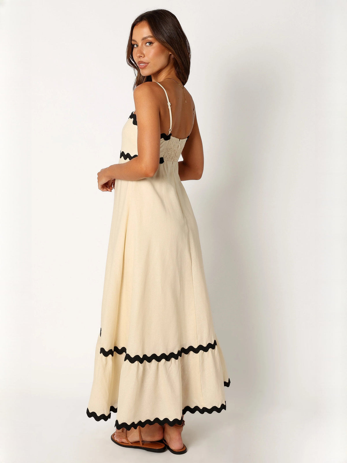 Black a-line maxi formal dress with strapless neckline, alternate full-length view showing the waist