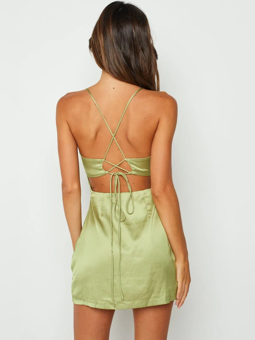 Backless sage green satin mini dress with crisscross straps and lace-up detail