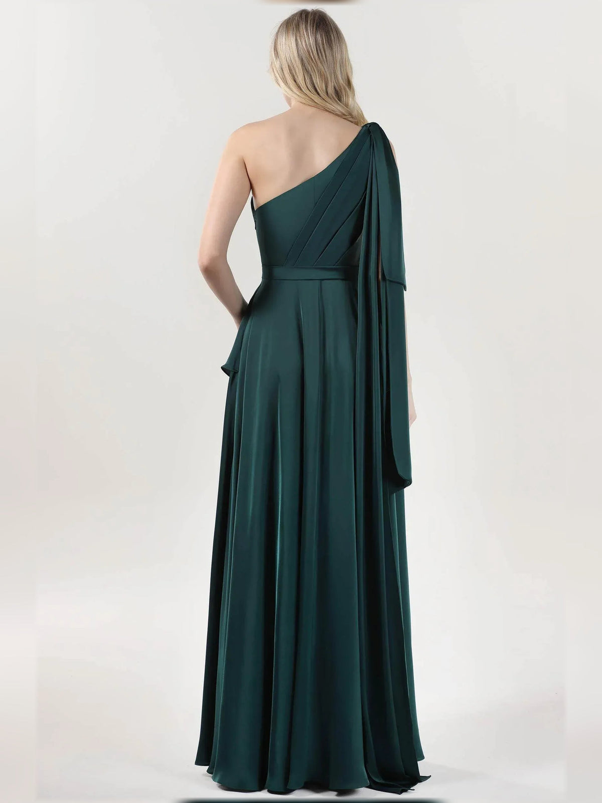 Back view of one-shoulder A-line formal dress in teal with trailing drape