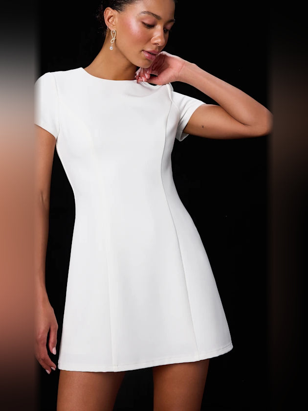 White short-sleeve mini dress close-up, crew neckline and flared skirt