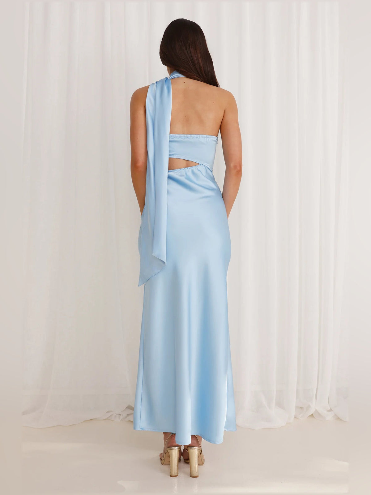 Light blue satin midi dress with open back and trailing halter drape