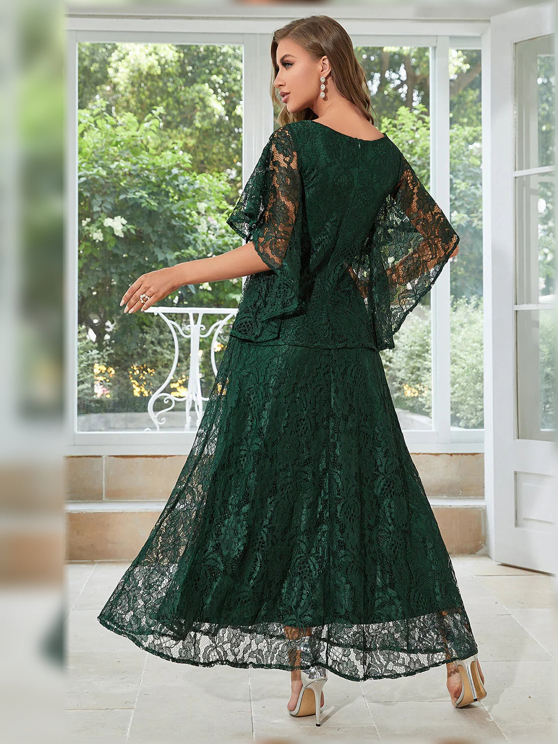 Dark green lace A-line formal dress, back view with sheer flutter sleeves, full-length skirt